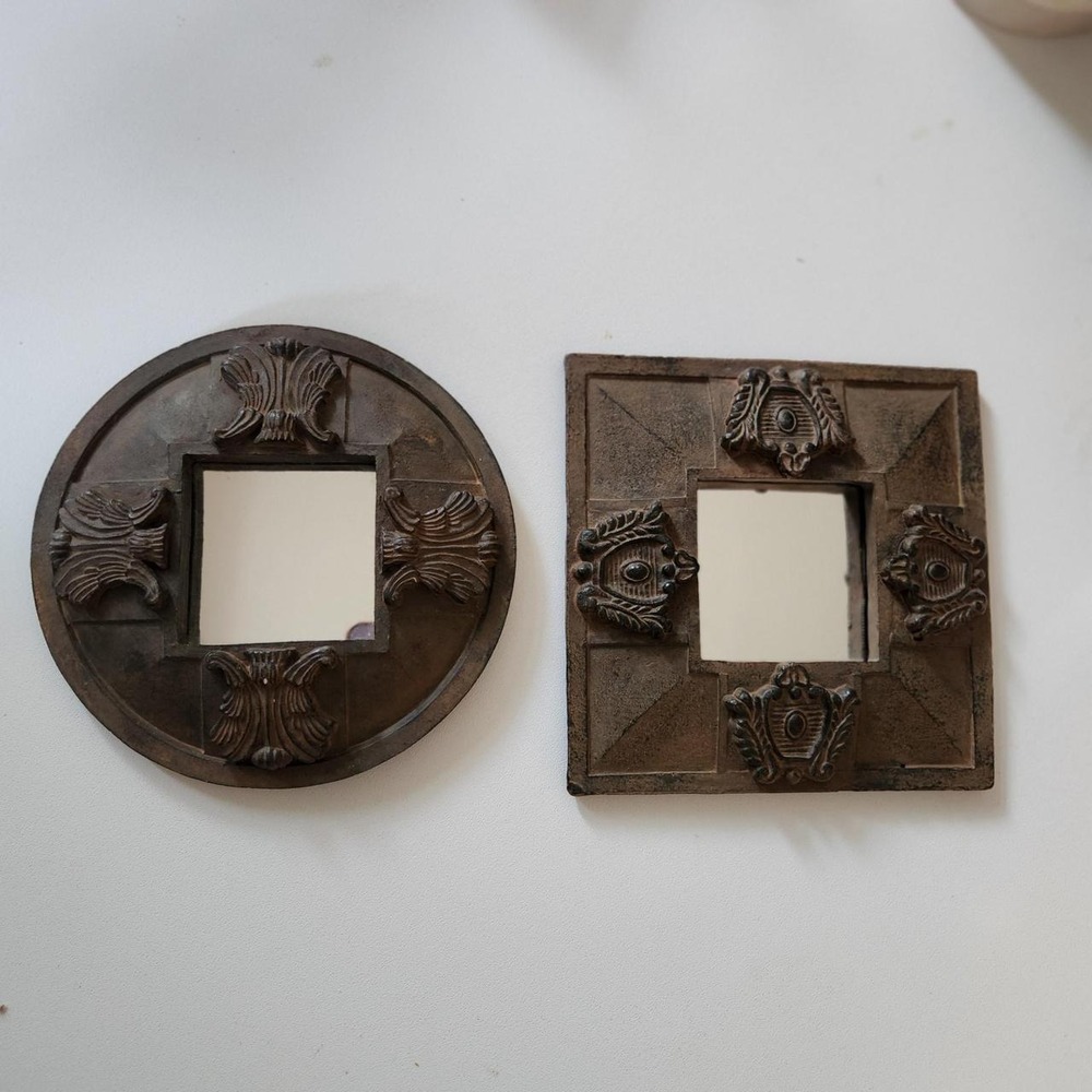 Set of 2 decorative ceramic wall mirrors featuring ornate raised detailing